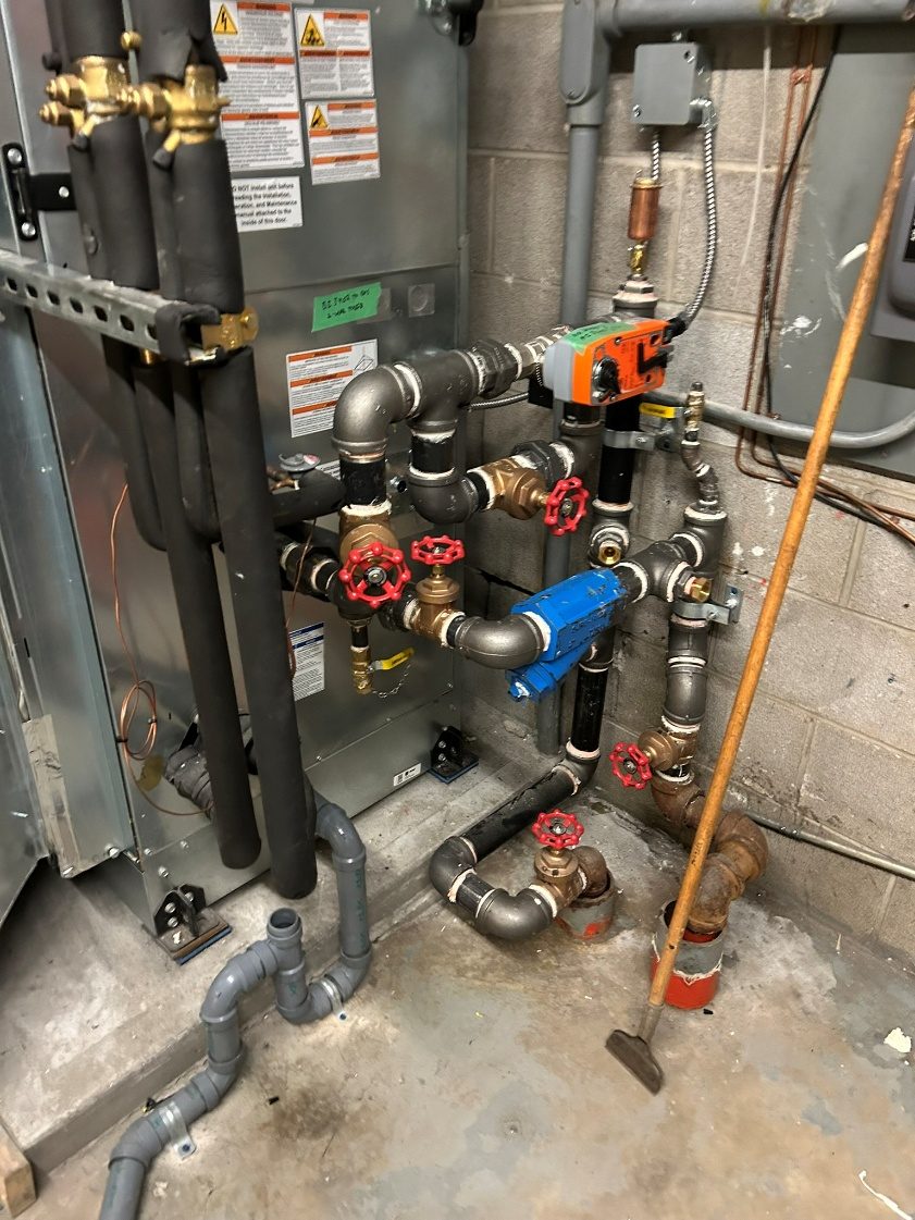 Bare boiler room pipes and valves before insulation