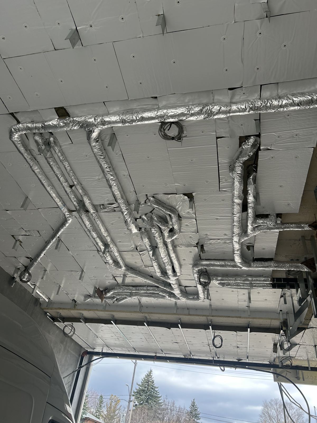Insulated overhead piping in a commercial build