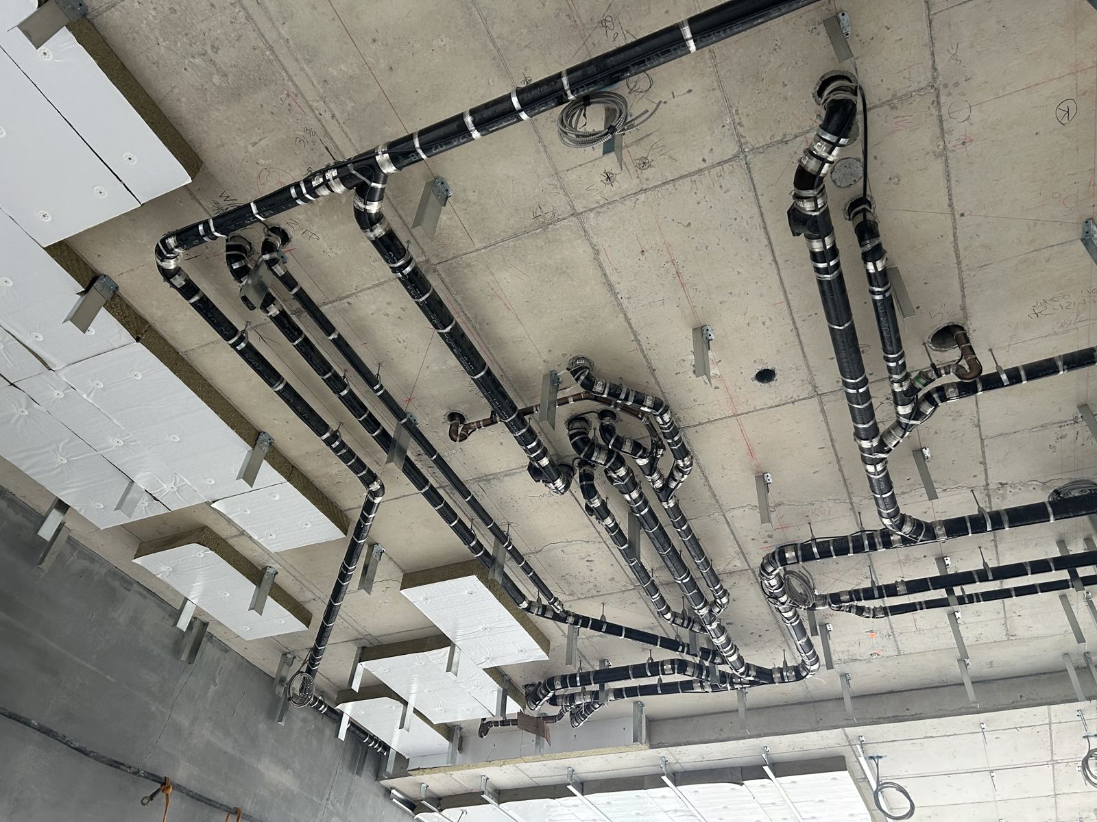Insulated refrigeration lines at ceiling level